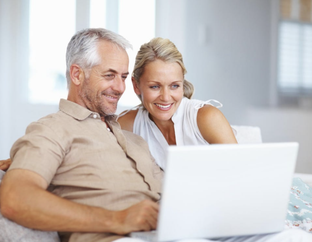 husband and wife 50 years old looking at computer for retirement planning
